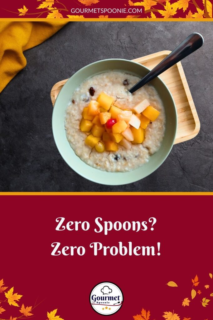 A bowl of oatmeal topped with diced peaches and cherries sits on a wooden tray with a black spoon. Autumn leaves border the image, and text reads “Zero Spoons? Zero Problem!” with the Gourmet Spoonie logo.