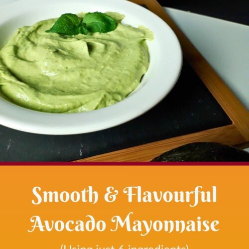 A white bowl of smooth, flavourful avocado mayonnaise, garnished with herbs, sits on a dark tray. Text below reads, “Smooth and Flavourful Avocado Mayonnaise (Using just 6 ingredients).”.