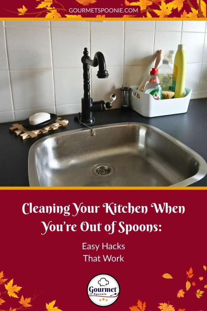 A kitchen sink with a black faucet, soap, and cleaning supplies on the counter; text below reads, “Cleaning Your Kitchen When You’re Out of Spoons: Easy Cleaning Hacks That Work.”.