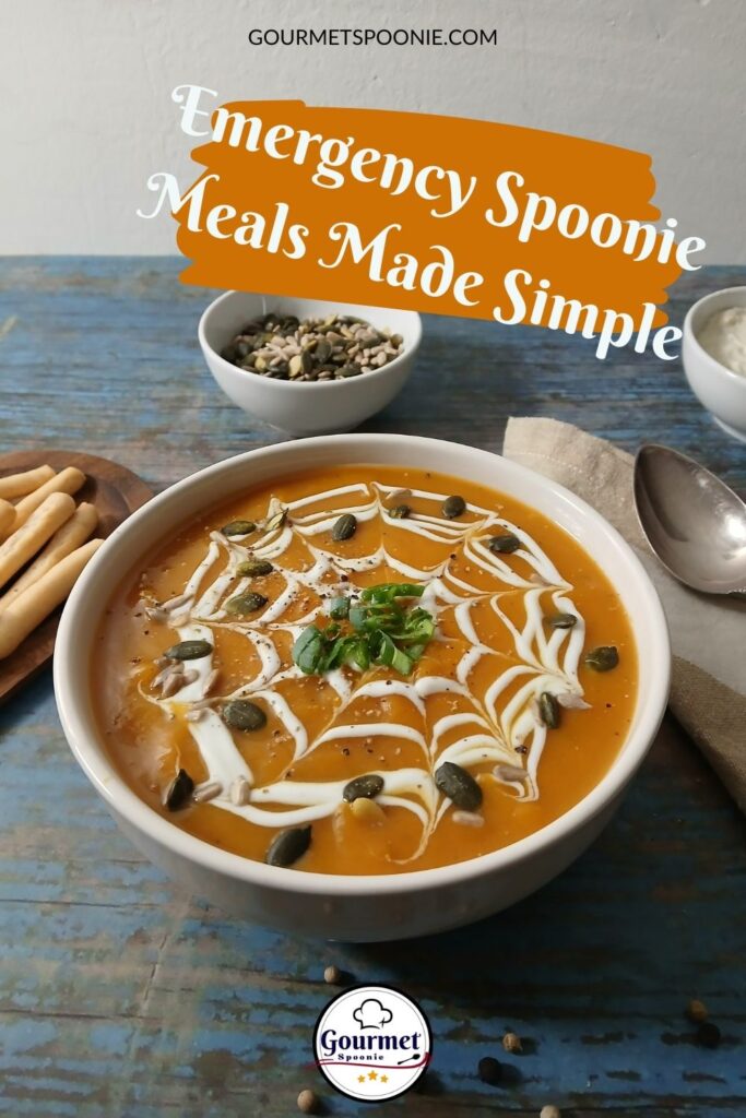 A bowl of orange soup topped with cream in a web pattern, seeds, and herbs sits on a table next to breadsticks, a bowl of seeds, and a spoon. Text reads: Emergency meals for spoonies made simple.