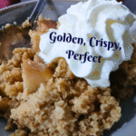 A close-up of a serving of easy apple crumble topped with whipped cream on a plate with a spoon. The text reads Golden, Crispy, Perfect. Autumn leaves border the image and a Gourmet logo appears at the bottom.