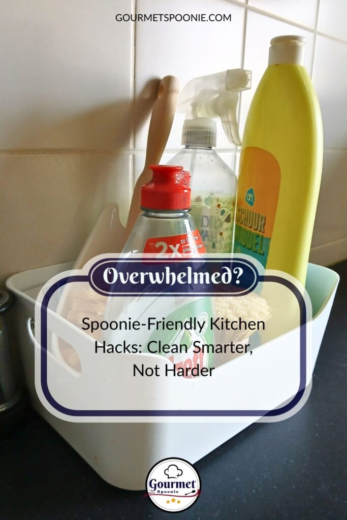 A white caddy holding cleaning supplies sits on a kitchen counter. Text overlay reads: Overwhelmed? Spoonie-friendly kitchen hacks—clean smarter, not harder—with a website header and logo.