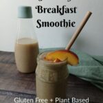 A mason jar filled with a smoothie, topped with peach slices and a straw, sits on a wooden table in front of a glass bottle of smoothie. Text on the image reads: Healthy Breakfast Smoothie. Gluten Free + Plant Based.