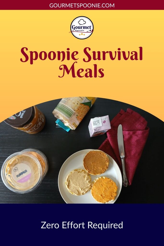 A plate with rice cakes spread with hummus and nut butter sits beside a fork, knife, napkin, and food containers. Spoonie Survival Meals—zero effort required. Visit gourmetspoonie.com for more easy meal ideas.
