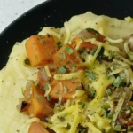 close up of easy slow cooker polenta with veggies and vegan Parmesan