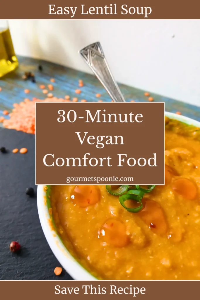 A bowl of lentil soup garnished with chopped spring onions sits on a table with a spoon inside. Red lentils and peppercorns are scattered nearby. Text reads: 30-Minute Vegan Comfort Food. Easy Lentil Soup. Save This Recipe.