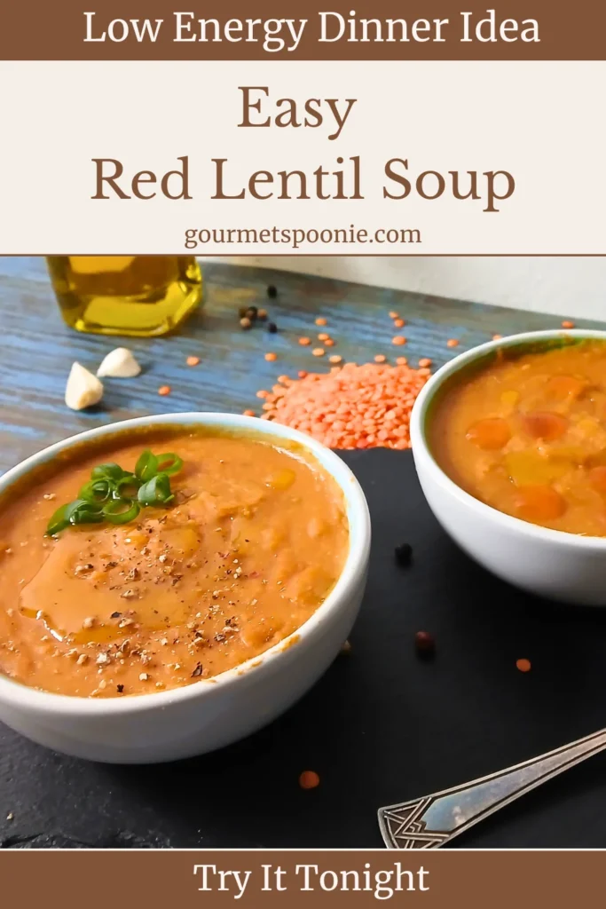 Two bowls of red lentil soup sit on a table with scattered lentils, garlic cloves, peppercorns, and a bottle of olive oil. The image promotes an easy, low-energy dinner idea: red lentil soup.