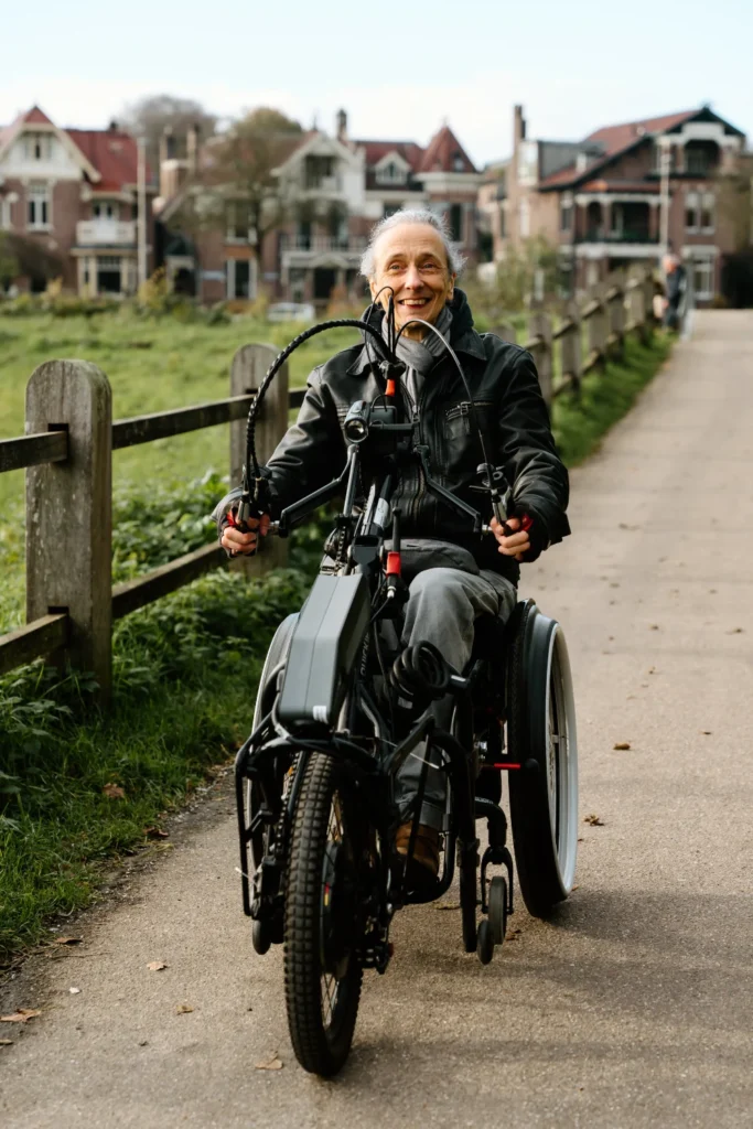 man in black leather jacket riding a handbike
