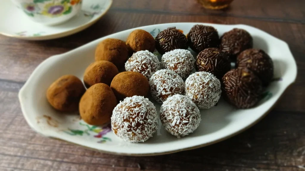 Healthy chocolate date energy bites served on a decorative tray.