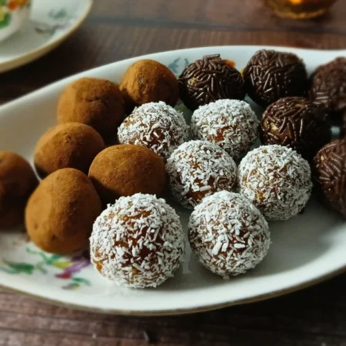 Healthy chocolate date energy bites served on a decorative tray.