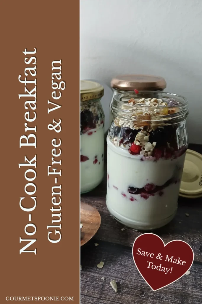 Mason jar breakfast parfait layered with gluten-free vegan muesli, yoghurt, and fresh fruit, ready to eat.