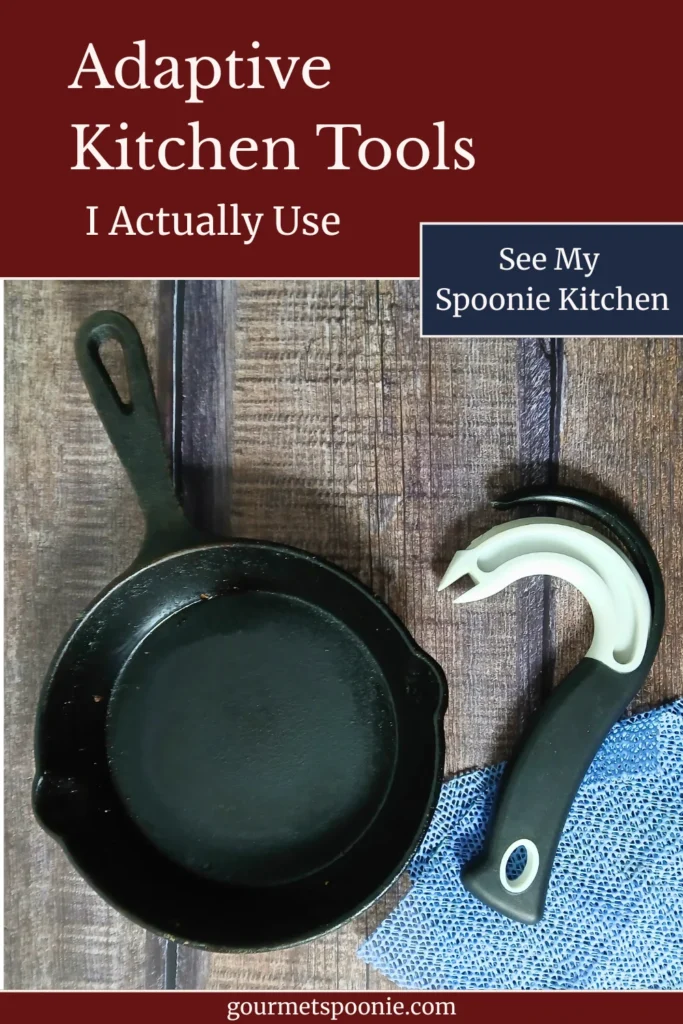 Top-down view of well-used adaptive kitchen tools on a wooden table: rubber jar grippers, a ring-pull can opener, and a small cast-iron frying pan.