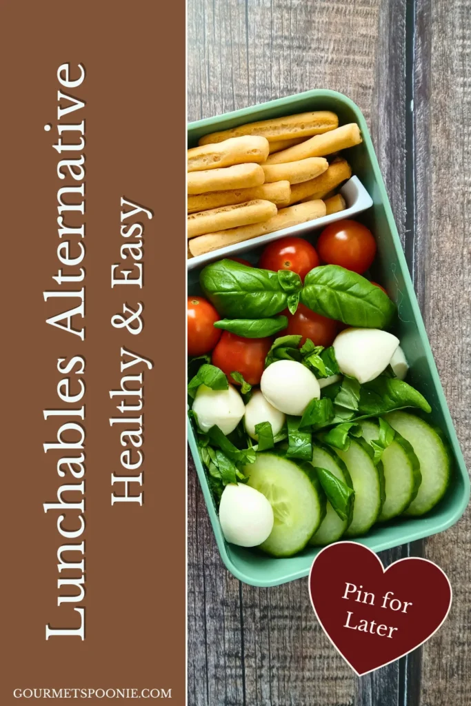 Italian-inspired healthy lunchbox with bread sticks, cherry tomatoes, basil, and mozzarella.
