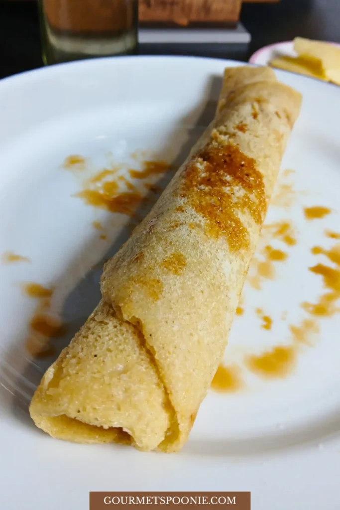 Rolled-up gluten-free Dutch pancake on a plate