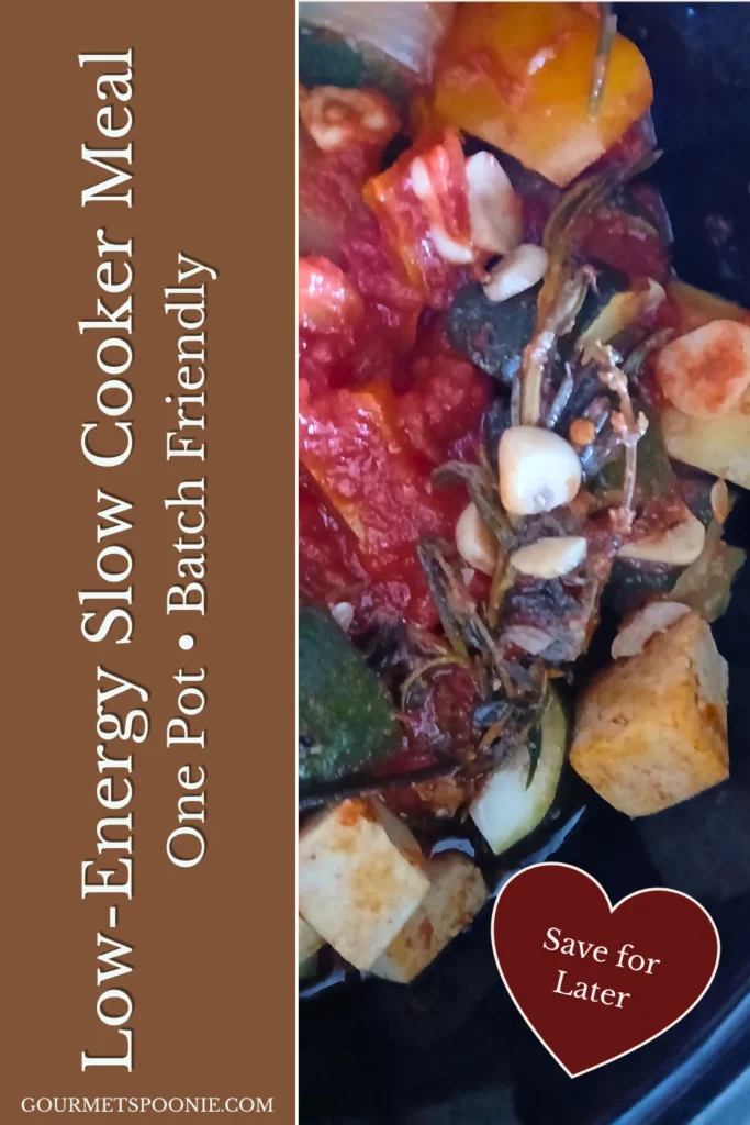 Slow cooker filled with vegetable ratatouille made with courgettes, peppers, potatoes, and tofu.