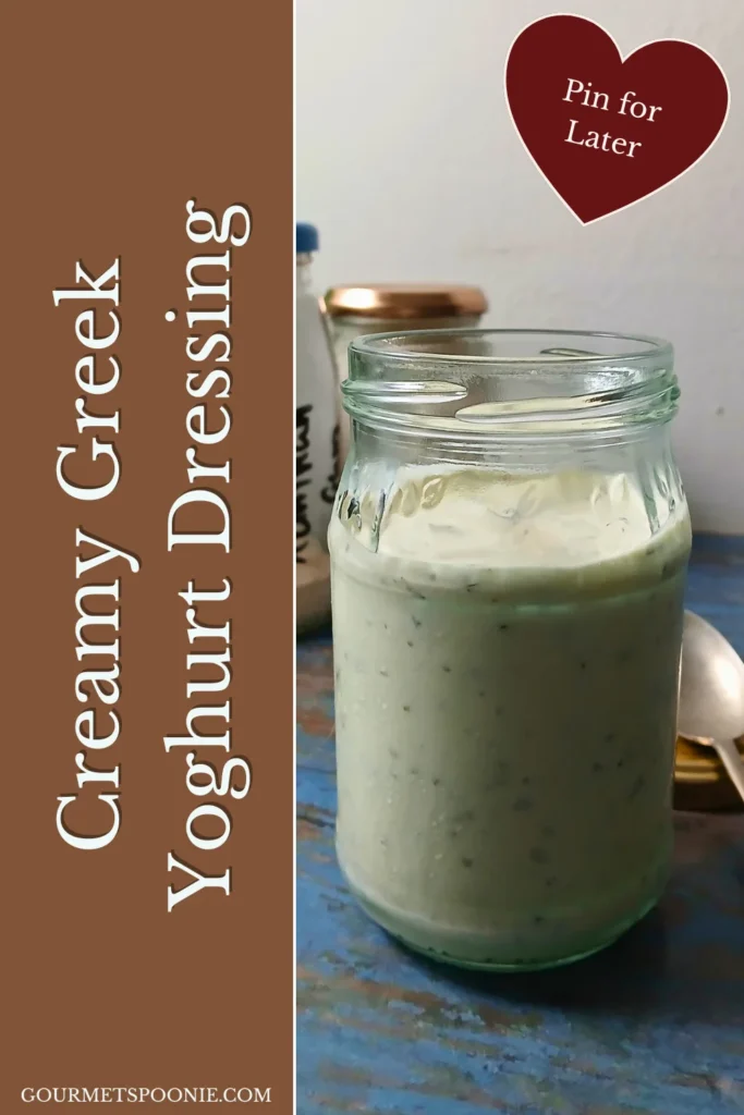 Homemade Greek yoghurt garlic dressing in a glass jar with dried herbs and garlic.
