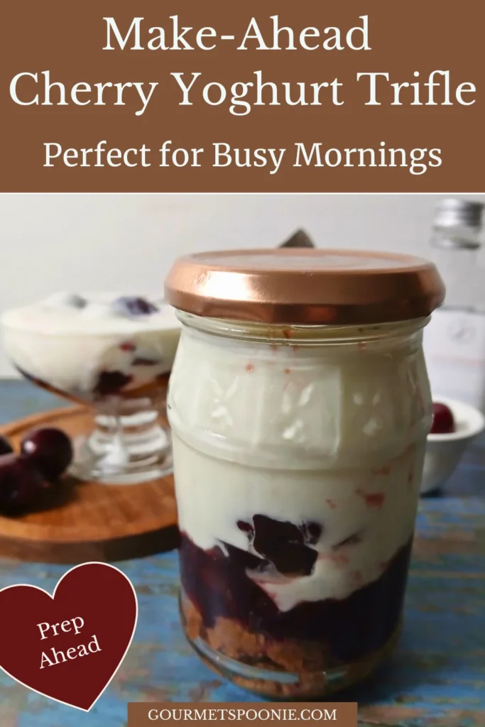 Cherry yoghurt trifle layered in a glass jar with cake, cherry jam, cherries, and yoghurt for an easy make-ahead breakfast.